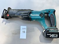 Side view of Makita cordless reciprocating saw with battery attached showing model and battery labels.