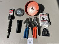 Full lot overview on neutral background showing drill bit, wire brush wheel, hole saw blade, hand snips, utility knife, and accessory blades.