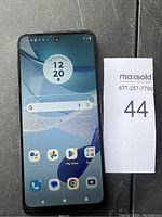 Front view of the Motorola smartphone screen turned on, showing UI and app icons