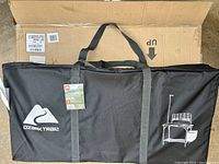 Black carrying case with Ozark Trail logo and schematic of camp kitchen table