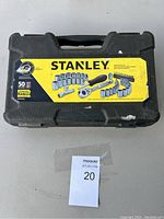 Closed black Stanley case with yellow and black label showing 50-piece ratchet socket set inside