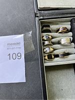 Close-up of the seven men's rings showcasing design details and finishes.