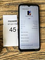 Front screen of Samsung Galaxy A14 5G showing 'About phone' screen with model and serial information.