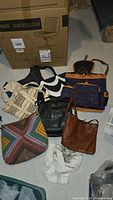 Overview photo showing seven assorted purses in various styles and materials, including patterned fabric and leather options.