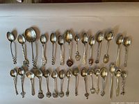 Overhead view of entire collection of two rows of spoons on white background