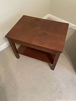 Wooden side table angled top view showing grain and finish.