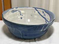 Front angled view showing interior and exterior glazing and drip patterns on ceramic bowl.