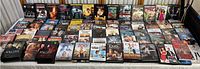 Overview photo of all DVD movies spread out on a table showing entire lot.