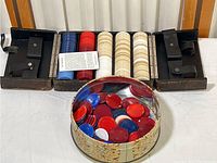 Poker chips in carrying case with interior slots, metal tin in front with loose poker chips
