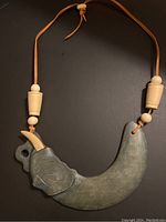 Full view of the vintage handmade elephant pendant necklace showing details of pendant and beads.