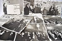 Multiple 8x10 black and white press photos spread out showing Texaco events and groups of men in suits from 1961, including a close-up of a board with 'The Birth of 1961' text.