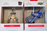 Front view of two Hallmark ornaments in packaging: Mayor from Disney and Bam the Batmobile from DC Batgirls.