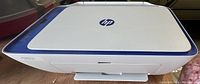 Top view of HP DeskJet 2622 printer showing white and blue casing and HP logo.