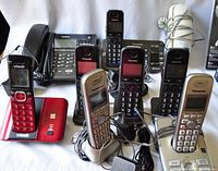 Photo showing all phones including Uniden wired desk phone, multiple Panasonic cordless phones, Vtech red button cordless phone, silver phones and Big Button phone.