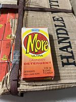 Close-up image of one orange box of More Ultra laundry detergent labeled for 2.02 oz (one load).