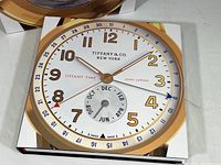 Front cover of book showing detailed watch face printed on dust jacket with date markings and hour numerals.