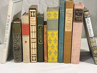 Full view of eleven classic books including Vanity Fair, Anna Karenina, The Oregon Trail, Andersen's Fairy Tales, The Rubaiyat of Omar Khayyam, The Three Musketeers, The Essays of Sir Francis Bacon, Leaves of Grass, Crime and Punishment, Tales from Chaucer, and The Rose and the Ring.