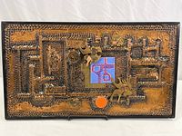 Full view of the hammered copper framed scene showing overall size and design with relief and textured patterns representing abstract interior elements and figures.