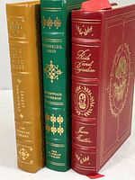 Spine view of the three hardcover books showing title, author, year, and Franklin Library embossing.