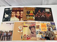 Eight vinyl albums laid out showing front covers of artists Harry Nilsson, The Mamas & The Papas, Blood Sweat & Tears, Peter Paul & Mary, Ella Fitzgerald, Nat King Cole.