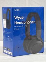 Sealed boxed Wyze wireless headphones with active noise canceling technology, front and side view.