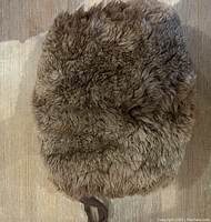 Top view of the brown fur muff showing the plush, soft fur texture.