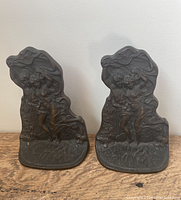 Front view of both metal bookends featuring dancing couple design.