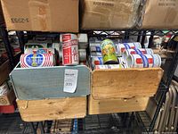 Four wooden boxes filled with vintage empty beer cans including Sterling and Beerding brands.