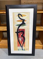 Full view of framed abstract art print with black frame and white matting showing colorful geometric and abstract brushstroke design