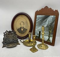 Overview of all items: portrait, mirror, brass candlesticks, letter holder