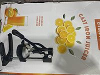 Box front panel showing image and description of the Eurolux cast iron citrus juicer and stainless steel cup included.