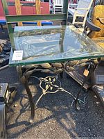 Full view of the card table showcasing the thick glass top with decorative metal frame holding it.