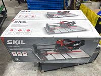 Box for SKIL 4-3/8 inch flooring saw showing front and top views with logos and features visible.