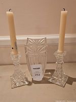 Front view of the Waterford crystal vase centered between the two crystal candlesticks with candles.