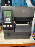 Front view of Zebra ZT411 label printer showing control panel with power supply error message on screen.