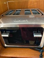 Front view of Cuisinart toaster showing the two levers and brand logo on front panel.