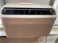 Front view of Frigidaire Gallery air conditioner unit, showing vent openings and power cord.
