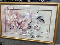 Full view of the framed Jan Kooistra floral artwork, showing the flowers and branches painted in soft pastel shades with the gold frame.