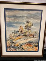Full view of framed watercolour painting showing a hillside scene with trees, sky, and natural landscape.