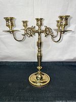Front view of vintage Baldwin brass 5-arm candelabra showing polished finish, ornate arms, and five taper candle holders.