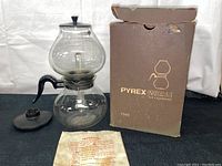 Full setup with vacuum coffee pot, lid, original brown Pyrex Ware box, and instructions sheet laid out.