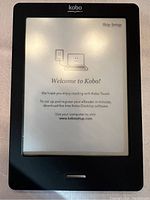 Kobo e-reader powered on showing welcome screen in black protective case.