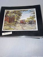Glen Road 1917 print on black mat backing within protective plastic sleeve, vintage cars and autumn street scene visible