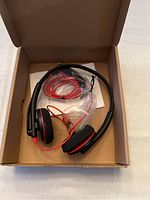 Plantronics Blackwire 3220 headset in box with cable and quick start manual.