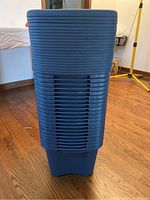 Stack of blue plastic storage boxes showing side ribbed detail