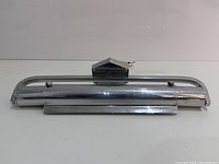 Front view of the vintage Art Deco chrome wall lamp with visible mounting bracket and smooth curved shade.