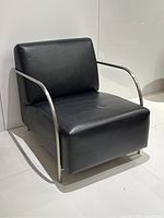 Front three-quarter view of black leather lounge chair