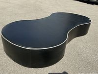 Ottoman shown on pavement, full top and side profile visible