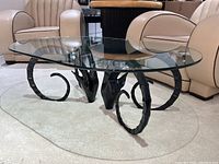 Front-side view showing oval glass top and dual ram head supports