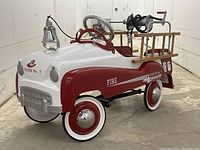 Three-quarter front-left view showing body paint, wheels, bell, ladders and hose reel.